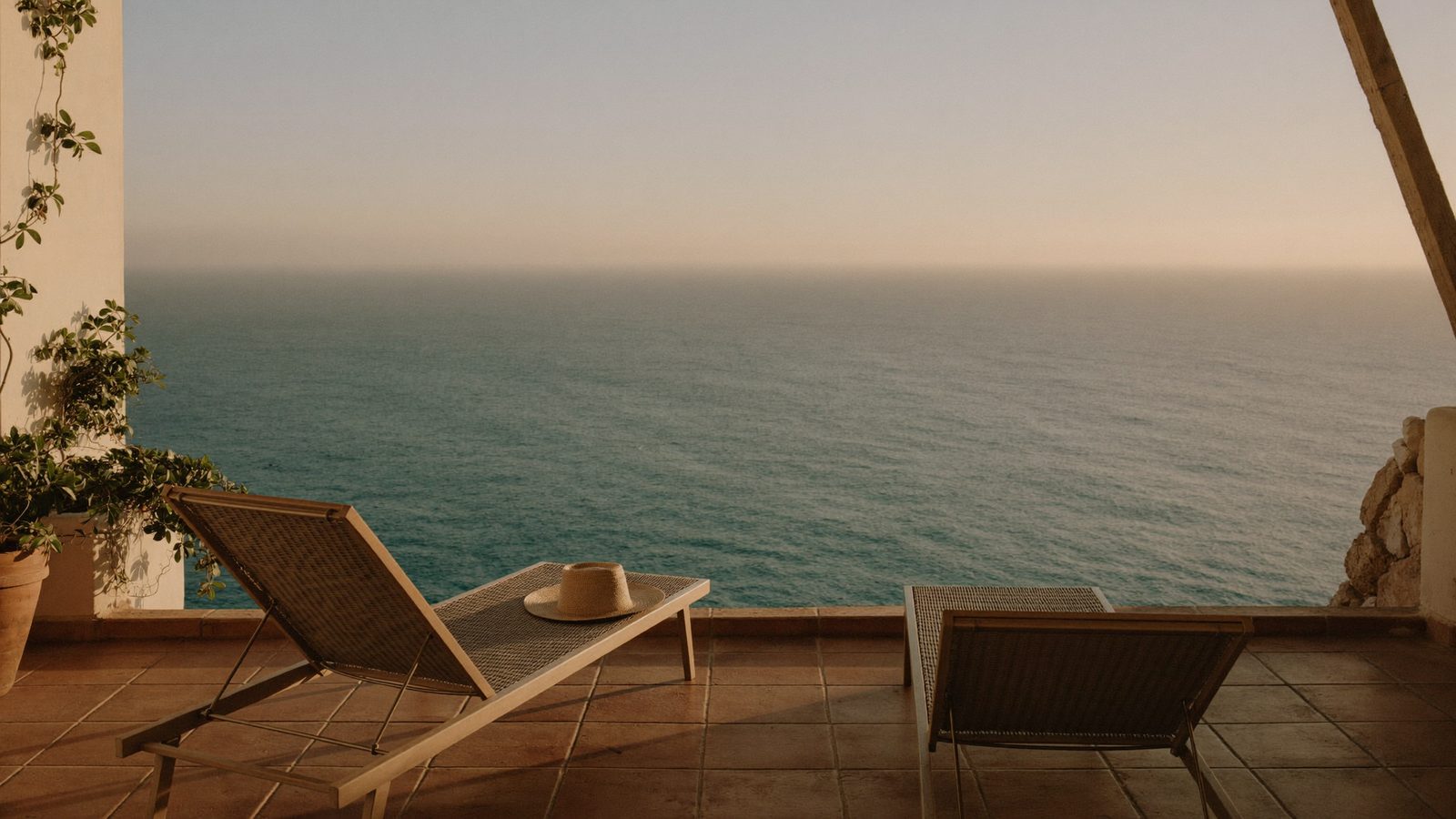 Empty sun loungers on an Andalusian terrace overlooking the Mediterranean — the half-year-in-Spain dream this guide reality-checks